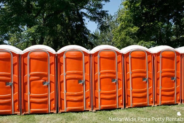 a lineup of clean and well-maintained portable loos for workers in Orford, NH